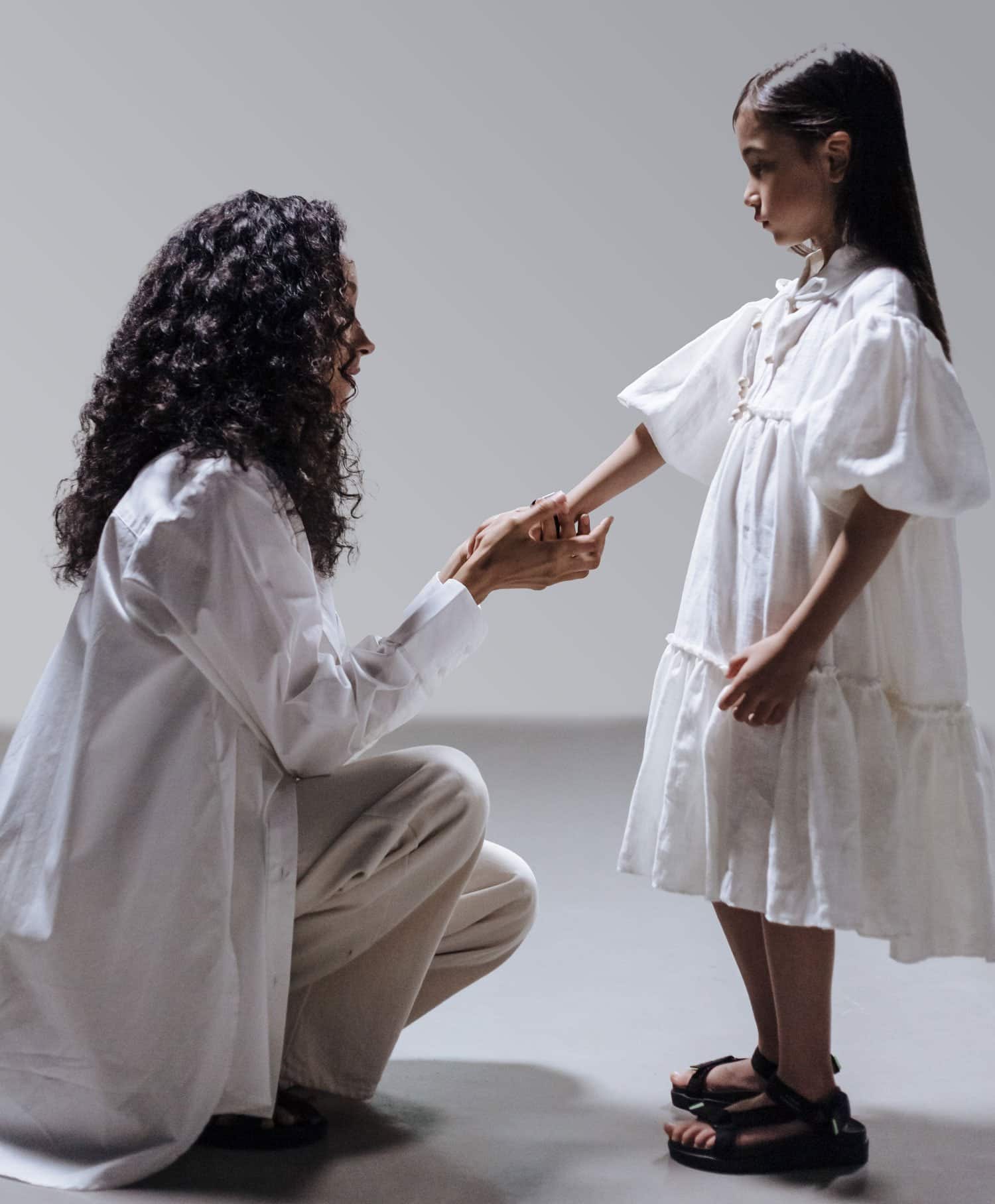 mother kneeling to talk to daughter