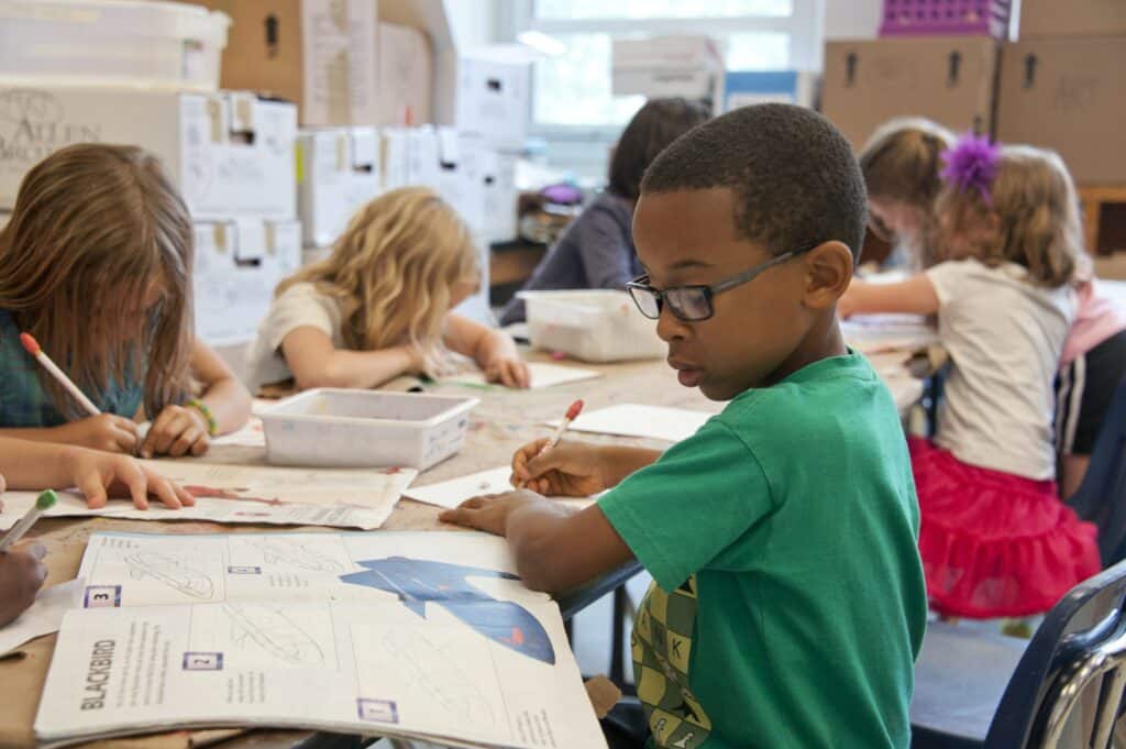 boy writing in school