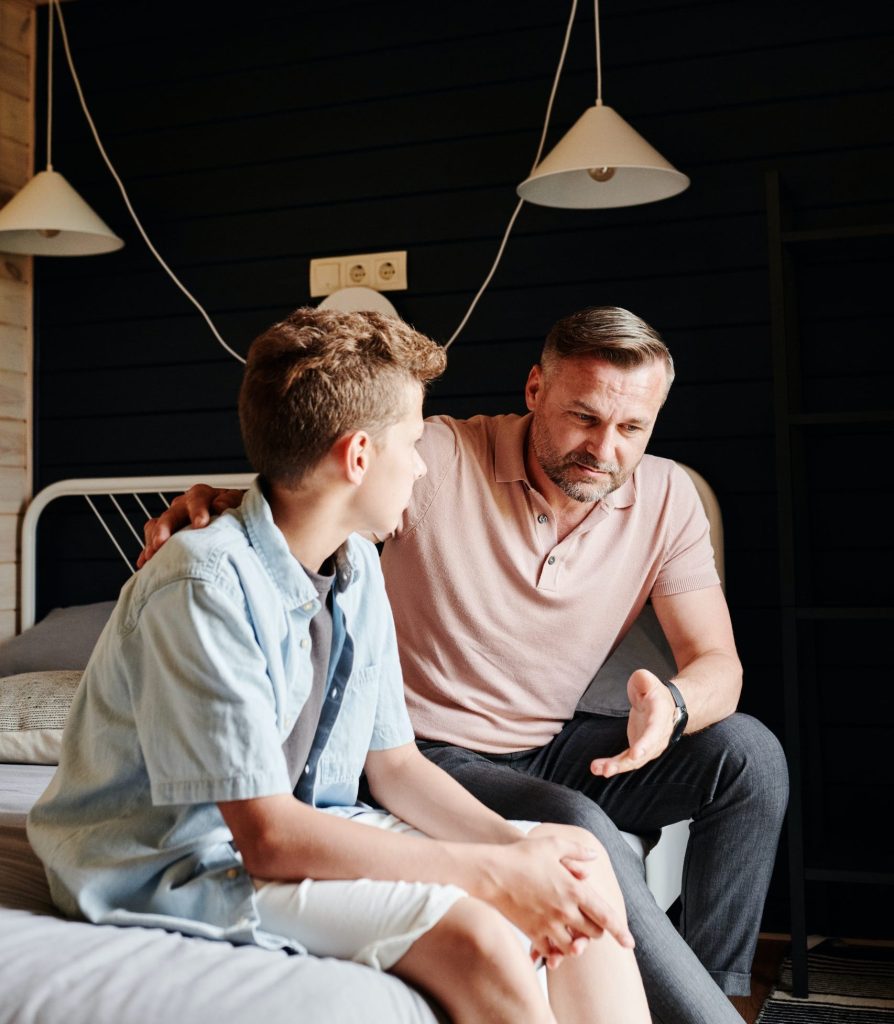 Dad talks to son in bed