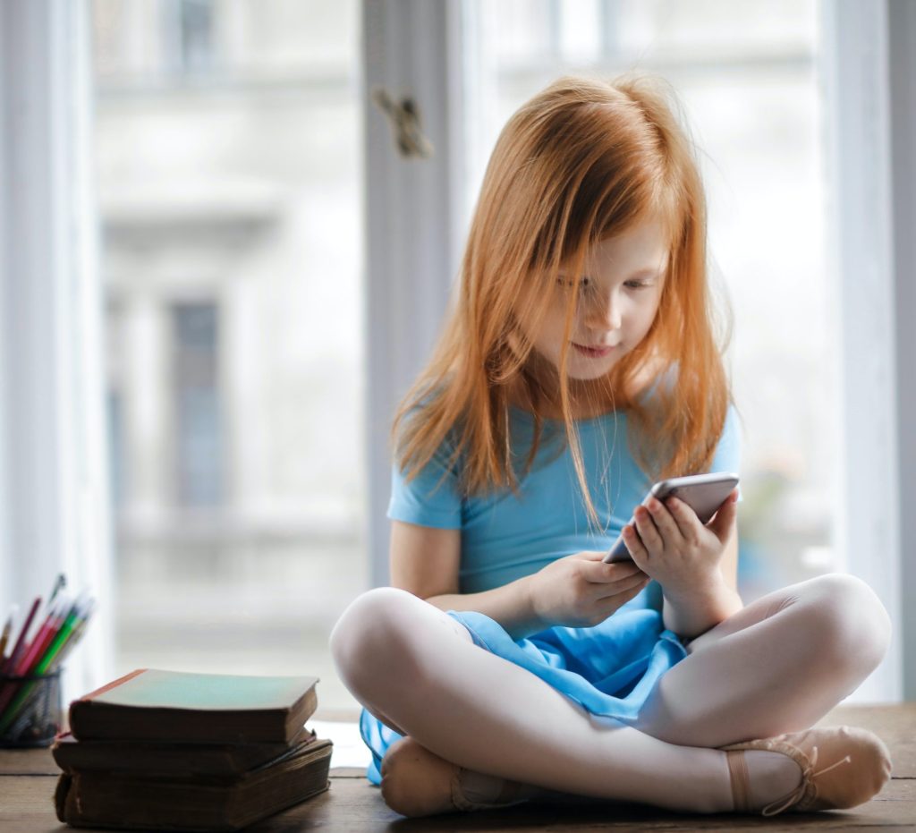 young girl on iPhone