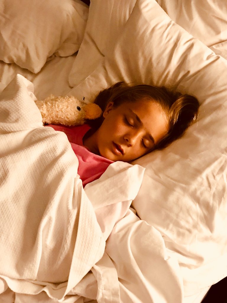 Girl sleeps with stuffed animal
